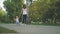 Mom and son walking in the park. First steps of little boy in summer park. Baby boy walking in the park with mom`s