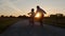 Mom teaches daughter to ride a bike. Happy family childhood dream concept of parent and little kids learn to ride a bike