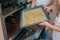 Mom teaches her daughters to cook in the kitchen. The family bakes cookies in the oven