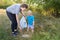 Mom teaches her son to clean up trash in nature. The topic of environmental pollution by garbage