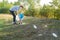 Mom teaches her son to clean up trash in nature. The topic of environmental pollution by garbage