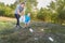 Mom teaches her son to clean up trash in nature. The topic of environmental pollution by garbage