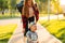 Mom teaches her son to ride a toy car in the park. Preschooler driving his toy car outdoors in summer