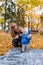 Mom teaches the kid to walk. Infant with the help of his mother takes the first steps in the park.