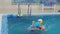 mom teaches to swim a little girl 2 3 years old. Mother and daughter practice swimming in the pool. children\'s sports