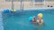 mom teaches to swim a little girl 2 3 years old. Mother and daughter practice swimming in the pool. children\'s sports