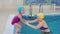 mom teaches to swim a little girl 2 3 years old. Mother and daughter practice swimming in the pool. children\'s sports