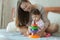 Mom teaching her baby with toys at home