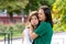 Mom and teenage daughter hugging on walk in park