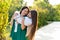 Mom and teenage daughter hugging on walk in park