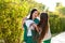 Mom and teenage daughter hugging on walk in park