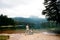 Mom and toddler daughter stand and look at Black Lake, Durmitor. Travel with kids. Family vacation.