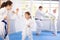 Mom trains daughter to do kicks at karate lessons