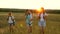 Mom travels with her daughters. mother and children are tourists. girls travel across field in sunset light. Hiker Girl
