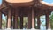 Mom turns in his arms her little daughter in beautiful Buddhist building with columns