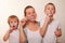 Mom and two blond boys brush their teeth