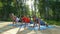 Mom and two boys performing yoga poses outdoors