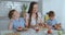 Mom with two children in the kitchen at the table preparing burger for lunch