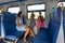 Mom and two daughters ride in an electric train, a general view of the seats