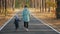 Mom walks with her little son in an autumn pine forest