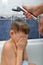 Mom washes shampoo from the head of a child whose eyes are closed