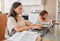 Mom working from home with distance learning child, multitasking childcare and work life balance during quarantine or