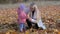 Mom with a young child collects beautiful leaf foliage