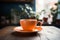 A moment of calm with an orange coffee cup on a table