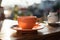 A moment of calm with an orange coffee cup on a table