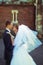 A moment before a kiss of newlyweds posing on the street