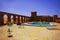 Moment of relaxation in a hotel swimming pool amids moroccan desert, with sand dunes on the horizon.