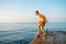 Moment of schoolboy jumping from pier into sea doing tricks