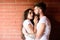 Moments of intimacy. Couple in love hugs brick wall background. Couple find place to be alone. Girl and hipster romantic