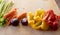 Moments of daily life in the Mediterranean cookery: low angle view of carrots, celery, peppers, onions in foreground on light