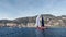 Monaco, Monte-Carlo, 06 November 2022: Sailboat near port Hercules at sunny day, sail regatta, mountain, massif of