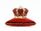 Monarch crown on red velvet cushion