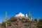 Monastery Chapel With Cross Framed By Two Saguaro Cactus In Desert