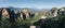 Monastery Meteora Greece. Stunning summer panoramic landscape. View at mountains and green forest against epic blue sky with