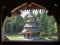 Monastery Sapanta-Peri in Maramures, Romania photographed through a sclupted window