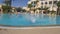 Monastir, Tunisia - 05 June 2018: funny girl teenager diving in deep swimming pool in hotel. Happy girl jumping in water