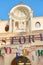 MONDOVI, ITALY - AUGUST 15, 2016: Funicular station entrance with beige facade and virgin Mary statue in a sunny day in Italy