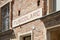 MONDOVI, ITALY - AUGUST 18, 2016: Funicular station entrance sign in red bricks wall in a sunny day in Mondovi, Italy