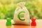 Money bag with Euro symbol and two people figures. Business Investment and lending, leasing. Business relationship. Dispute