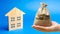 Money bag and wooden house. Real estate investment concept. Business and finance. Mortgage, loan, taxes, debts. Family home budget