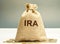 Money bag with the word IRA - individual retirement account. Tax-advantaged account that individuals use to save and invest for