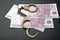 Money banknote handcuffs leather background