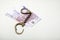 Money banknote handcuffs leather background