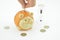 Money box as pig and time clock. Orange thrift-box for money with hourglass