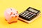 Money budget planning. Calculate profit. Piggy bank pink pig and calculator. Financial wellbeing. Economics and finance