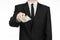 Money and business theme: a man in a black suit holding a bill of 100 dollars and features a hand gesture on an isolated white bac